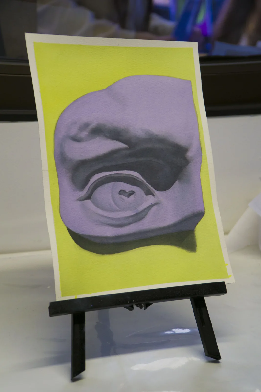 Acuarela sobre papel: ojo del David sobre fondo amarillo, ejercicio de veladuras de la alumna Florencia Sauterel